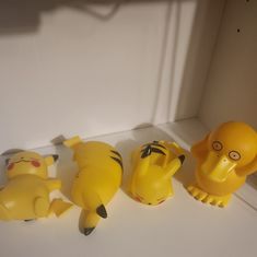 three plastic toy animals sitting next to each other