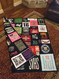 a black blanket covered in stickers on top of a rug