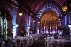 the banquet hall is decorated with white linens and gold sashes, as well as floral centerpieces