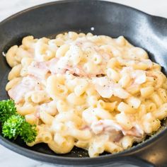 macaroni with ham and broccoli in a skillet on the table