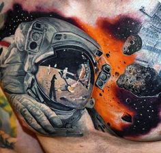 a man's chest with an astronaut tattoo on it