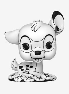 a white and black animal figurine sitting on top of a table