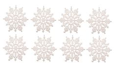 six snowflakes hanging from strings on a white background