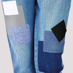 a person wearing blue jeans with different patches on it's sides and one patch in the pocket