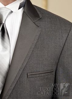 a man wearing a gray suit and tie