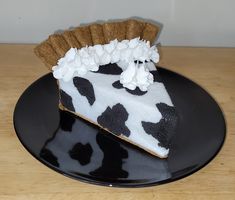 a piece of cake on a black plate