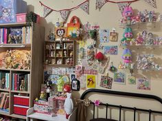 a room filled with lots of stuffed animals and toys on the wall next to a bed