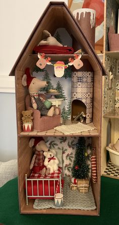 a doll house with lots of furniture and decorations on the shelves in front of it