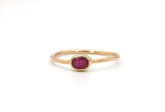 Minimalist, simple ruby solitaire ring using a recycled old oval cut ruby bezel set in a 14k yellow gold ring. Color may vary slightly based on the supply.   DM me for any customization requests.  Round version available https://www.etsy.com/listing/951442768/minimalist-rose-gold-ruby-ring-bezel-set Gemstone: Natural Ruby Cut: oval cut Weight: 1 = 0.33 cts estimated weight Measurements: 4.5 x 3.2 x 2.2 mm Color: pinkish red Clarity: eye visible inclusions Dimensions: 4.2 - 1.1 mm wide x  2.1 mm off the finger Finger Size: size 6 current in stock Metal: available in 14k rose gold, 14k white gold & 14k yellow gold (specify at checkout) Markings: none Weight 0.8 grams Condition Rating: 10 (new ring set with recycled old ruby) Gold Ruby Ring With Bezel Setting, Oval Cabochon, Modern Oval Ruby Ring With Bezel Setting, Minimalist Oval Stackable Rings With Bezel Setting, Minimalist Gold Ruby Ring With Bezel Setting, Oval Stackable Ruby Ring In Yellow Gold, Classic Oval Stackable Ruby Ring, Classic Oval Ruby Ring Stackable, 14k Gold Stackable Rings With Smooth Bezel, Dainty Oval Ruby Ring In 14k Gold