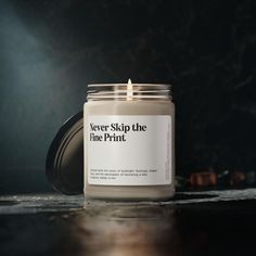 a candle that is sitting on top of a table with the words never skip the line print