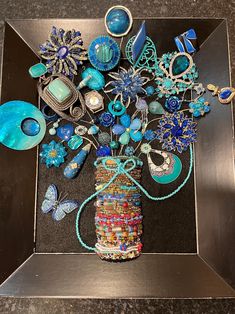 a vase filled with lots of different types of jewelry