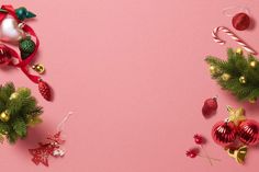 christmas decorations and candy canes on a pink background