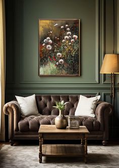 a living room filled with furniture and a painting on the wall above it's coffee table