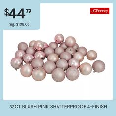 a pile of pink christmas balls sitting on top of each other