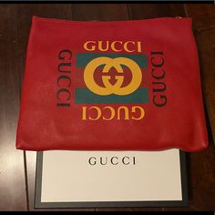 A Pouch Makes For A Great Travel Accessory. This Gucci Pouch Is Crafted From Red Leather And Styled With The Logo On The Front. The Zip Top Closure Opens. Designer Shopping Clutch Pouch, Designer Pouch Clutch For Shopping, Gucci Designer Wallets With Logo, Designer Leather Pouch For Gifts, Designer Gucci Wallets With Logo, Luxury Gucci Clutch, Designer Clutch Pouch For Shopping, Luxury Gucci Wallet With Logo, Designer Clutch For Shopping