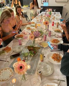 a group of people sitting around a table eating food