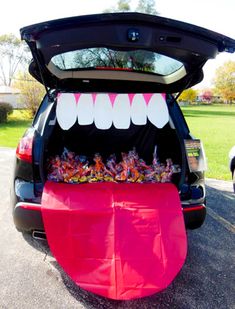 the trunk of a car is decorated with teeth and candy