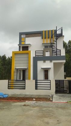 a white and yellow house with stairs on the side