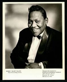 a black and white photo of a man in a tuxedo