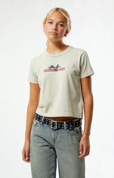 The Hollywood LA Dreams Eagle T-Shirt from PS / LA is your go-to for a chic, casual look. Featuring short sleeves and a crew neckline, it has a slightly cropped length with a relaxed boxy fit. Bold Hollywood Los Angeles eagle graphics adorn the front and back, adding a touch of standout style.Solid color teeShort sleevesCrew necklineFront & back graphicsSlightly cropped lengthRelaxed boxy fit100% cottonMachine washableModel is wearing a size smallModel measurements: 5’7.5” height, 32” bust, 24” waist, 35” hips PS / LA Womens Hollywood LA Dreams Eagle T-Shirt - Brown size XS Short Sleeve Cropped T-shirt With Text Print, Graphic Print Cropped T-shirt With Short Sleeves, Short Sleeve Top With Front Print, Everyday Short Sleeve Top With Front Print, Graphic Print Crew Neck Short Sleeve Top, Casual Crew Neck Cropped T-shirt With Screen Print, Casual Short Sleeve Crew Neck Top With Graphic Print, Everyday Graphic Tee With Crew Neck, Trendy Cropped T-shirt With Crew Neck And Front Print