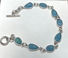 A wearable piece of history, our Roman Glass Toggle Bracelet is handcrafted with fine sterling silver and authentic Roman glass bringing history and modern-day design together in a beautiful and unique piece. 7.5" oxidized sterling silver toggle bracelet is slightly hammered and features 8mm x 13mm pear and 8mm x 11mm oval Roman glass. Matching earrings and necklace available. Comes with Certificate of Authenticity. .925 Sterling Silver Adjustable Sterling Silver Bracelet With Toggle Clasp, Sterling Silver Adjustable Bracelet With Toggle Clasp, Adjustable Sterling Silver Bracelet With Toggle Clasp For Gift, Christian Bracelets, Roman Glass, Earrings And Necklace, Toggle Bracelet, Glass Bracelet, Religious Jewelry