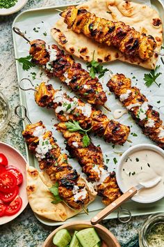 grilled chicken skewers with pita bread, cucumber and tomatoes