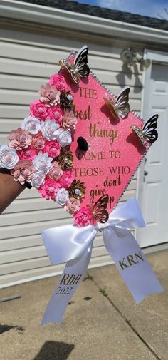 someone is holding up a pink and white graduation cap with butterflies on the front, which reads the dead thing came to those who they didn't