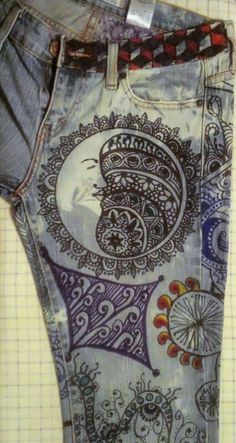 a pair of jeans with designs on them