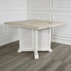 a white table sitting on top of a hard wood floor