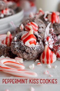 chocolate peppermint kiss cookies with white and red candy canes on the top