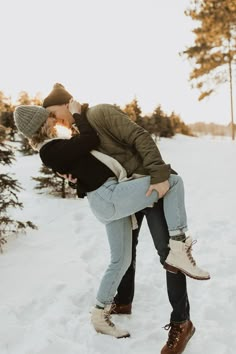 a man and woman kissing in the snow