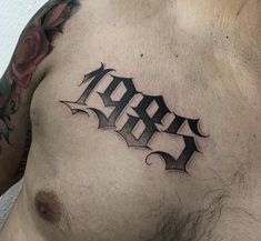 a man with a tattoo on his chest has the word arr written in black ink