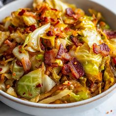 a white bowl filled with cabbage and bacon