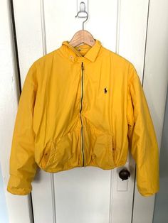 "Vintage Polo Ralph Lauren Yellow Jacket Made in Hong Kong Womens size M MADE IN HONG KONG 100% COTTON Lined 80% Cotton 20% Acrylic Has kind of a puffer look Short jacket Boxy fit Small or medium Chest:44\" Total Length:22\" Sleeve Length :29 More vintage clothing: https://www.etsy.com/shop/ElectricEyeThrift?sort_order=price_desc§ion_id=27044881 ✶ VINTAGE ✶ Please note that this item is vintage. Wear and tear representative of its age may be present. Anything major will be in the description, bu Casual Yellow Track Jacket For Fall, Yellow Long Sleeve Track Jacket For Winter, Vintage Yellow Long Sleeve Windbreaker, Yellow Vintage Long Sleeve Windbreaker, Casual Yellow Long Sleeve Track Jacket, Yellow Jacket Outfit, Polo Ralph Lauren Jacket, Cropped Faux Fur Coat, Ralph Lauren Jacket