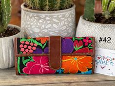 "This beautiful embroidered purse with traditional colorful flowers accents is perfect for any occasion. These purses are unique for their embroidered vibrant colors that add a bohemian look. It has a magnetic clip for closure and an additional pocket inside. Dimensions 8.5\" X 4\" More colors available here: https://www.etsy.com/es/listing/988769434/cartera-mexicana-con-bordado-floral?ref=listings_manager_grid" Everyday Embroidered Wallets, Traditional Multicolor Wallet For Everyday Use, Daily Use Embroidered Rectangular Wallet, Traditional Multicolor Wallet, Traditional Embroidered Rectangular Wallets, Traditional Handmade Multicolor Wallets, Traditional Multicolor Handmade Wallets, Embroidered Multicolor Coin Purse As Gift, Frida Kahlo Dress