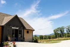 a small wooden building sitting on top of a gravel road