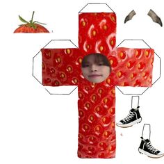 a cross made out of strawberries with a child's face in the center