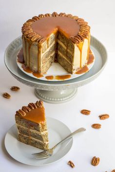 a piece of cake on a plate with a fork next to it and another slice missing