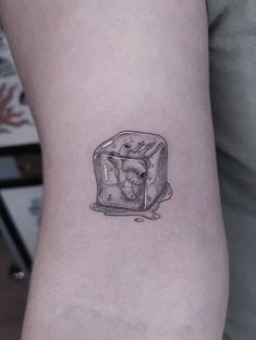 a small black and white drawing of an ice cream sandwich on the left inner arm