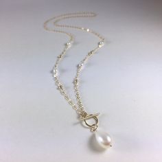 "IF YOU LIVE OUTSIDE THE US AND WOULD LIKE TO ORDER FROM MY SHOP, PLEASE MESSAGE ME FOR DETAILS. Freshwater Pearl Necklace, Gold Pearl Necklace, Real Pearl Necklace, Teardrop Pearl Necklace, Beaded Chain Necklace, Toggle Clasp Necklace, Gemstone Necklace, Pearl Jewelry, June Birthstone, Pearl Necklace for Women, Bridal Jewelry, Bride Necklace So elegant, this lovely necklace consists of a delicate 14k gold filled chain embellished with round gold and freshwater pearl beads with a teardrop pearl Elegant Pearl Toggle Necklace With Pearl Charm, Elegant Toggle Necklace With Pearl Charm, Gold Toggle Necklace With Pearl Charm, Elegant Gold Toggle Necklace With Pearl Drop, Elegant Gold Toggle Necklace With Pearl Charm, Gold Pearl Elegant Toggle Necklace, Elegant Gold Pearl Toggle Necklace, Delicate Gold Pearl Lariat Necklace, Gold Pearl Lariat Necklace With Delicate Chain