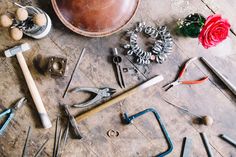 there are many different tools on the floor next to each other, including hammers and pliers