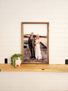 a man and woman standing next to each other on a shelf