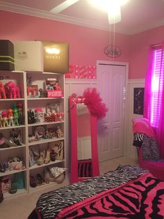 a bedroom decorated in pink and zebra print