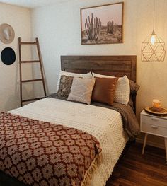 a bed in a room with a wooden headboard and ladder on the wall next to it