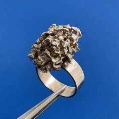 * Artisan 925 Sterling Silver Free Form Modernist Nugget Ring  * Size 7.5 * Band Width: 1/4" * Top of Ring Length: 7/8" * Top of Ring Width: 1/2" * Ring Height: 9/16" * Weight: 15 g * Unmarked * Professionally assayed. * Condition: As Pictured * s5054    Exported By ExportYourStore :) Modernist Sterling Silver Wedding Rings, Modernist Hand-cast Sterling Silver Jewelry, Sterling Silver Nugget Rings For Anniversary, Brutalist Ring For Anniversary, Silver Nugget Jewelry For Anniversary, Untreated White Gold Ring Jewelry, Brutalist Style Anniversary Ring, Modernist Hand Cast Sterling Silver Rings, Handmade Silver Cluster Ring For Anniversary