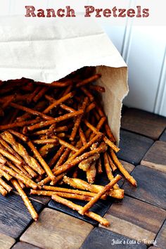 a bag full of french fries sitting on top of a wooden table