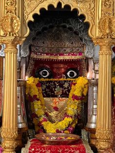 an idol is adorned with flowers and garlands