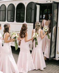 the bridesmaids are getting on the bus to go to their wedding ceremony in pink dresses