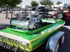 a green and white car with an engine on it