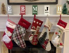 christmas stockings hanging from the mantel in front of a fireplace with letters on it